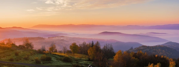 Soft abstract illustration of a calm morning landscape with a warm glowing horizon